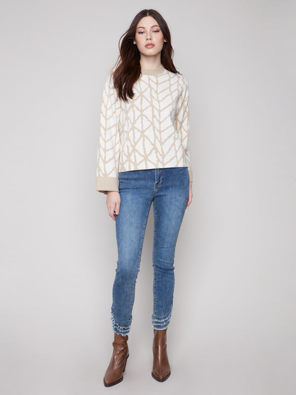 Chic ecru sweater with jacquard design, featuring a comfortable relaxed fit and folded cuffs for added style by Charlie B.