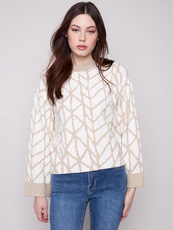 Ecru jacquard sweater featuring a cozy crew neckline and elegant folded cuffs for a refined look by Charlie B.