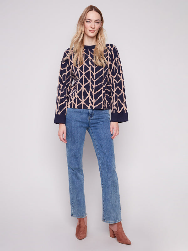 Stylish navy blue sweater featuring folded cuffs and an intricate jacquard design by Charlie B.