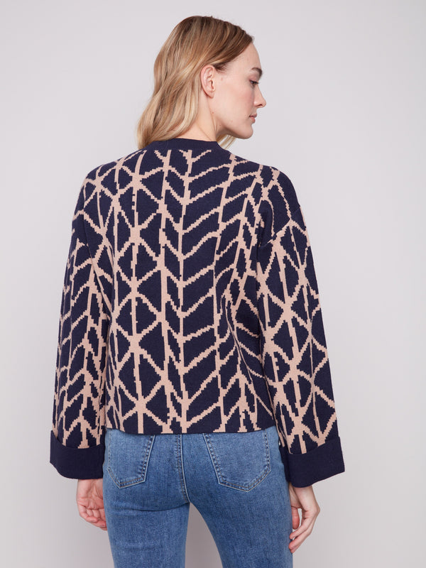 Elegant navy blue sweater with a crew neckline and bold geometric patterns by Charlie B.
