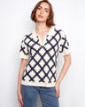 Chic crochet top in navy and cream, featuring short sleeves and a standout geometric pattern by Charlie B.