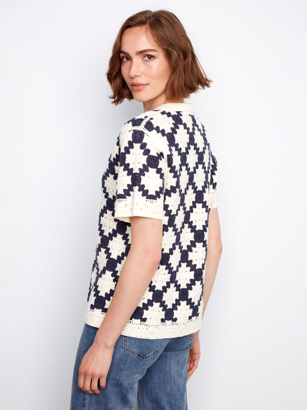 Sophisticated short-sleeve crochet top with a striking geometric design in navy and cream by Charlie B.