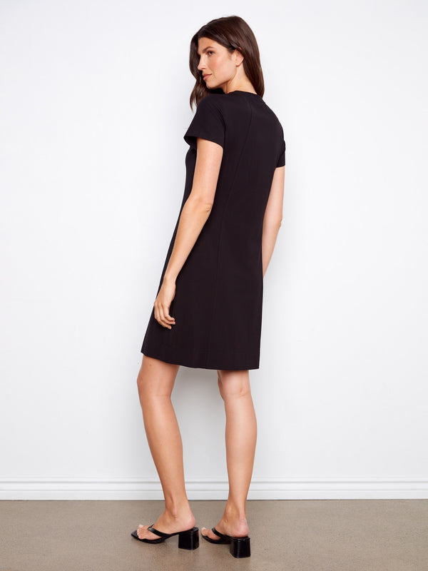 Sophisticated black dress offering a flattering fit with its crew neckline and side pockets by Charlie B.