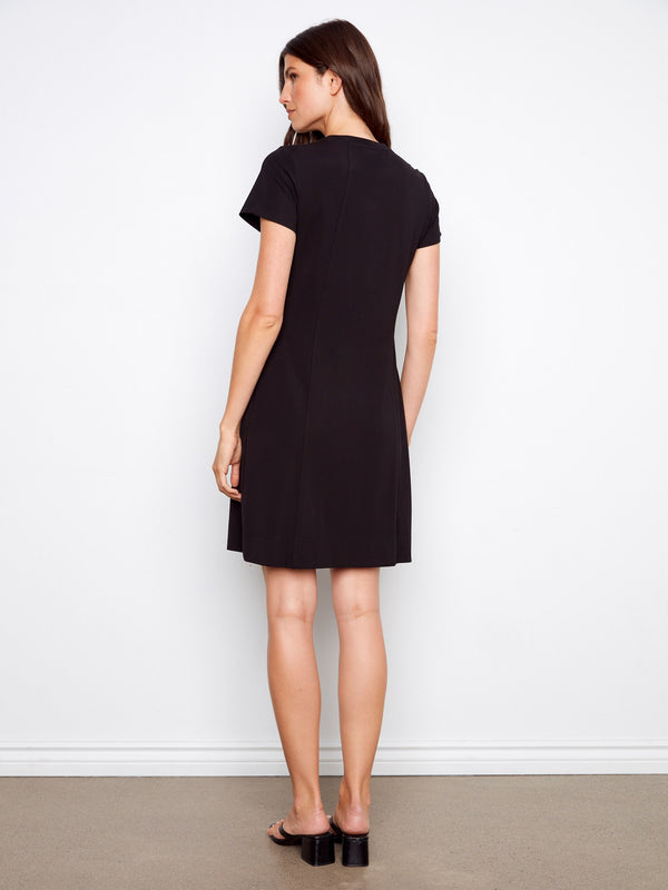 Classic black knee-length dress with understated elegance, complete with short sleeves by Charlie B.