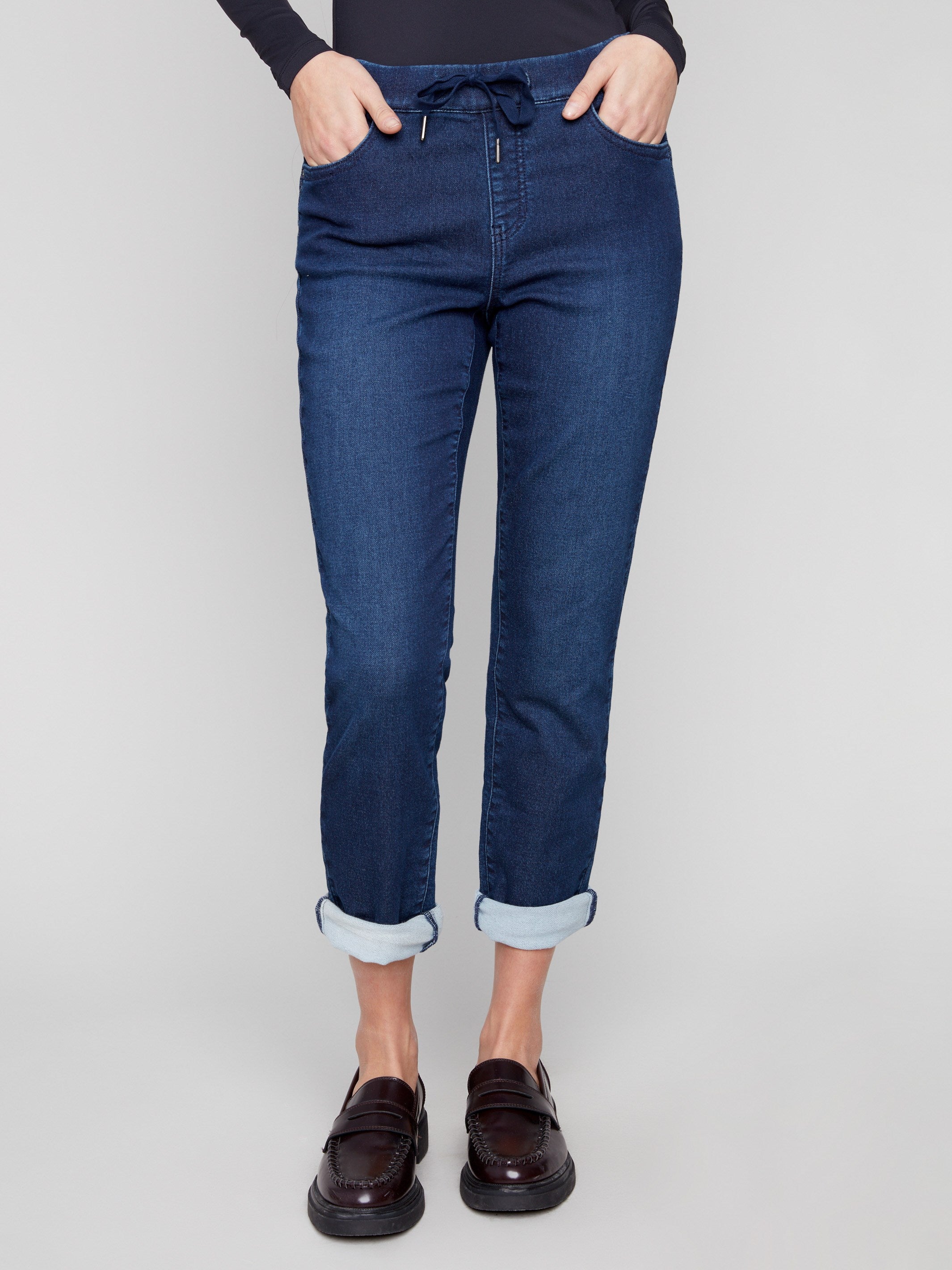 These indigo joggers offer a mid-rise waist with an elastic waistband and drawstring for comfort by Charlie B.