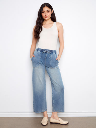 Blue knit denim jogger pants featuring slash pockets and elastic waistband with drawstring by Charlie B.