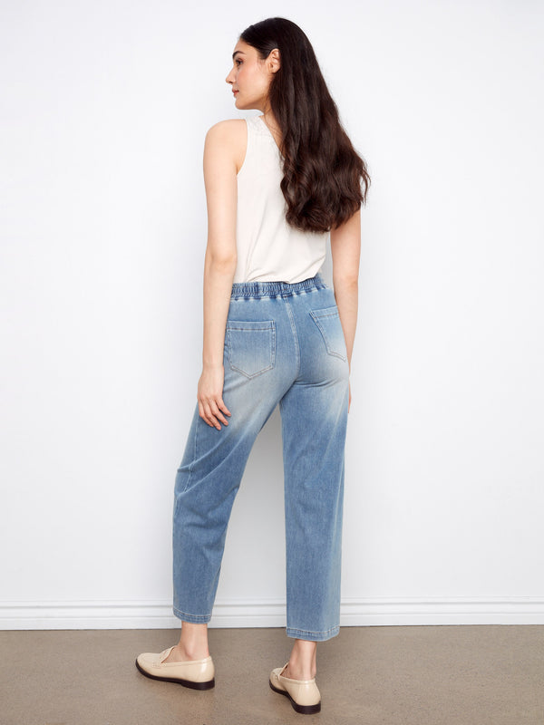 Knit denim pants in light blue showcasing an elastic waistband and wide-leg style by Charlie B.