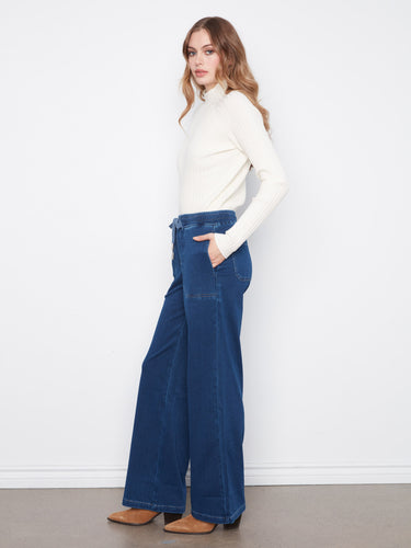 Featuring slash pockets, these pants combine practicality with fashion-forward design in stretch knit denim by Charlie B.