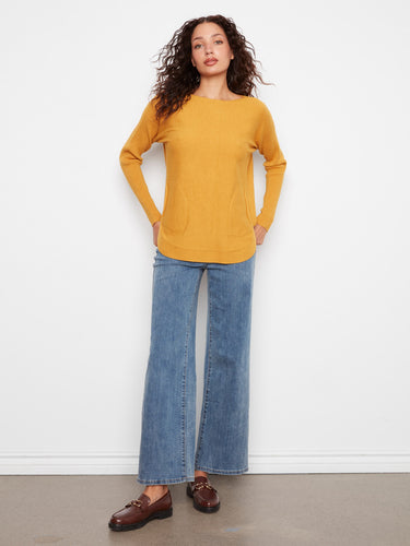 Mustard sweater with long sleeves for warmth and style, ideal for layering during cooler months. Crafted by Charlie B.
