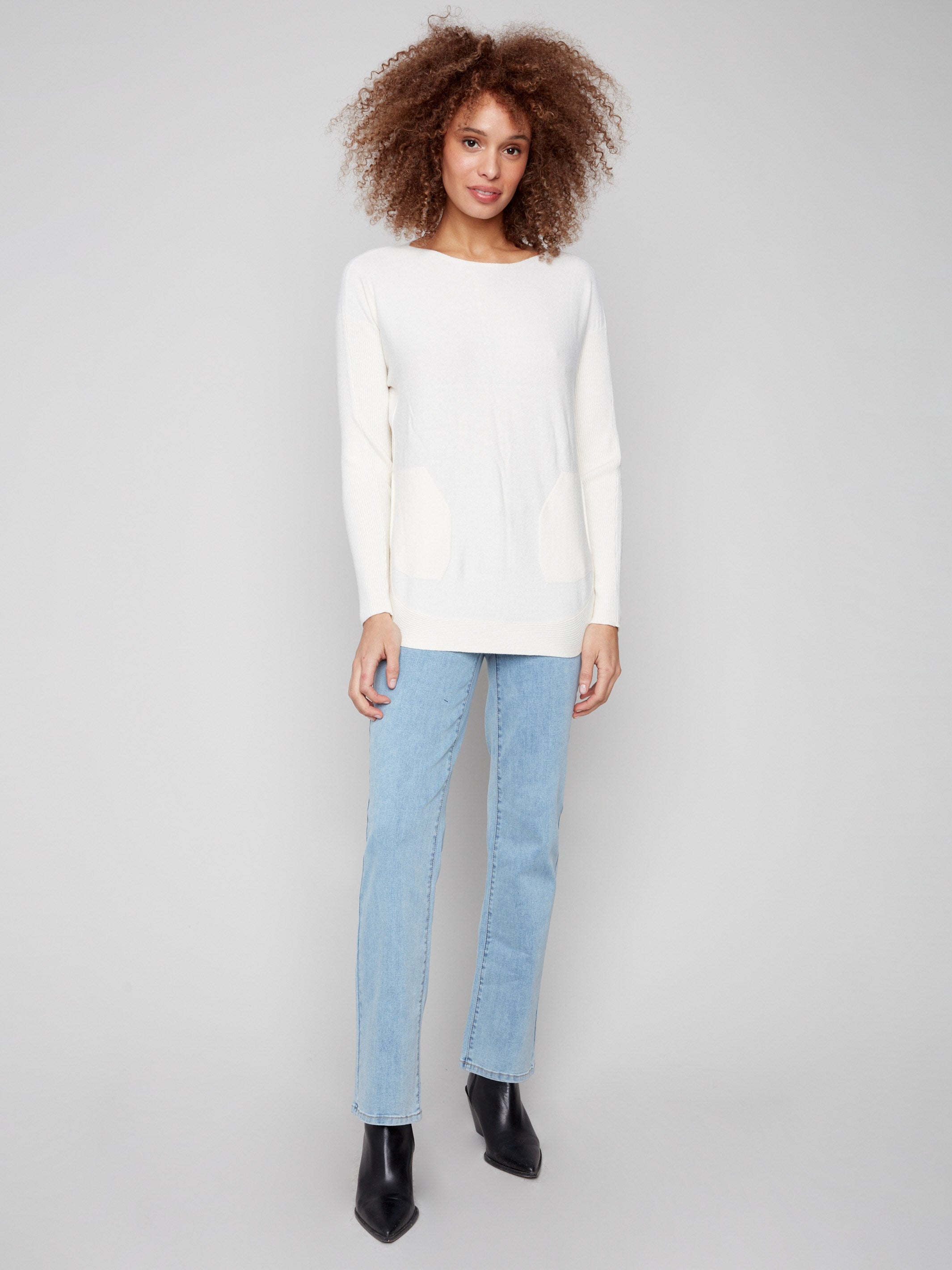 Cozy ecru knit with long ribbed sleeves and rounded hem, ideal for layering in cooler weather by Charlie B.