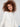 Stylish ecru sweater designed with convenient front pockets and rounded hem for added flair by Charlie B.