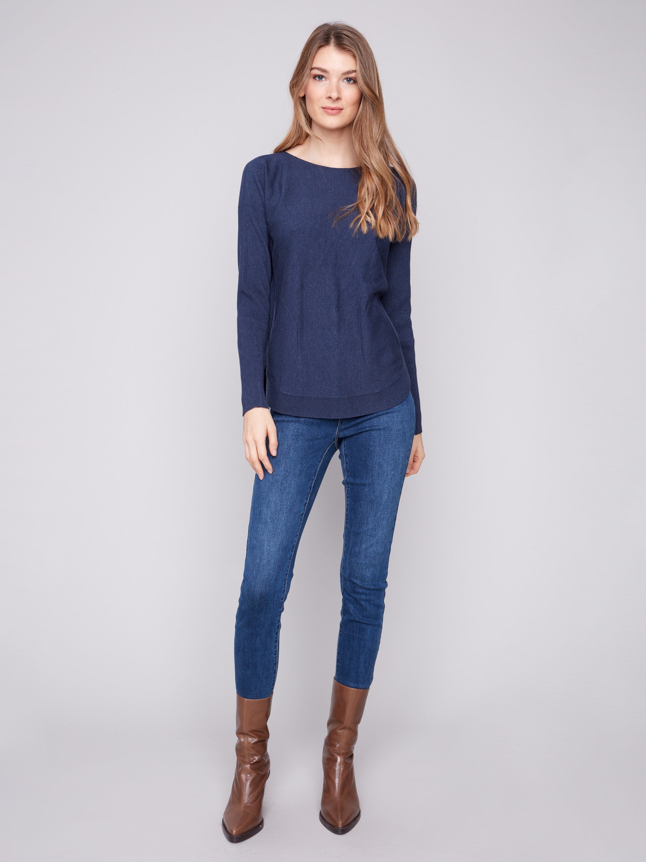 Chic denim knit sweater complete with practical front pockets for added convenience by Charlie B.