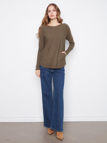 Featuring convenient front pockets, this sweater combines practicality with style effortlessly. Designed by Charlie B.