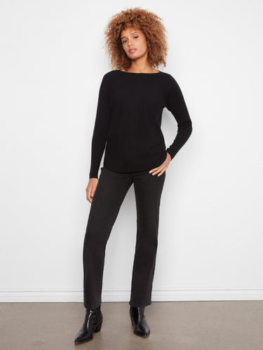 Chic black long-sleeve knit sweater with ribbed sleeves, offering both style and comfort by Charlie B.