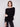Sophisticated black sweater designed with convenient front pockets for added style by Charlie B.