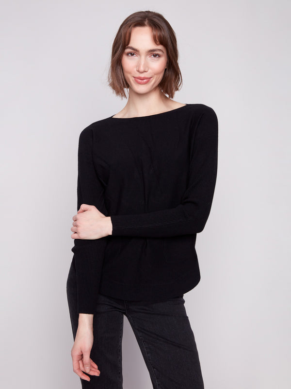 Sophisticated black sweater designed with convenient front pockets for added style by Charlie B.