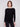 Stylish black knit sweater showcasing a flattering rounded hem design by Charlie B.