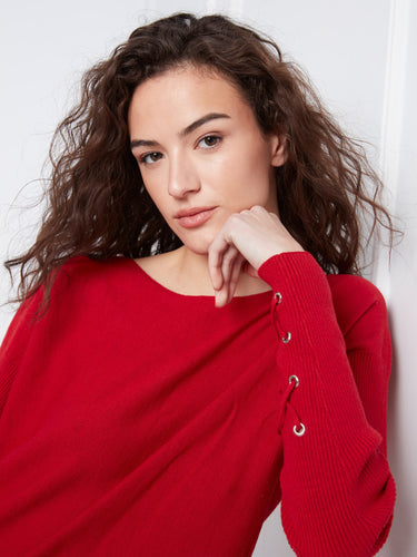 Chic red sweater featuring cuff lace-up detail, offering a unique twist on classic knitwear. By Charlie B.