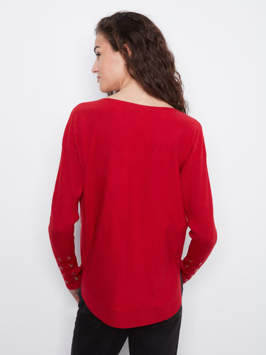 Cozy red sweater designed with convenient side pockets for added functionality and style. By Charlie B.