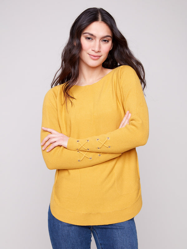Honey knit sweater featuring a stylish boat neck design and ribbed texture by Charlie B.