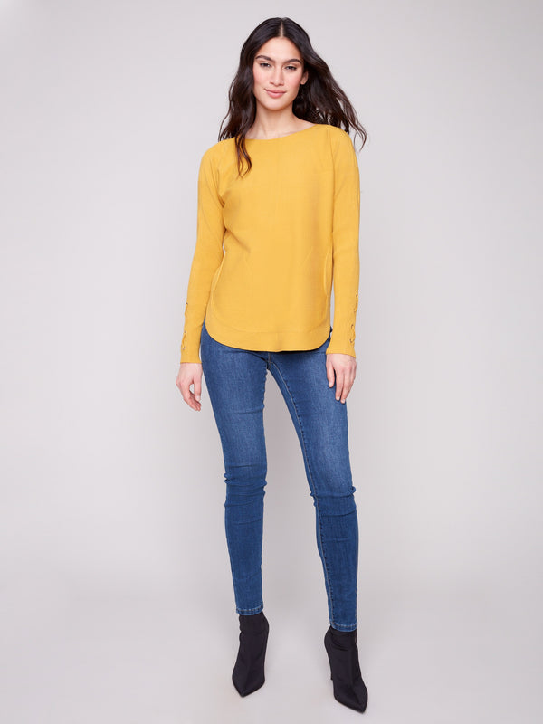 Elegant honey knit sweater with convenient side pockets for added functionality by Charlie B.