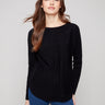 Black knit sweater featuring a boat neck design, complemented by long ribbed sleeves for a sleek look by Charlie B.