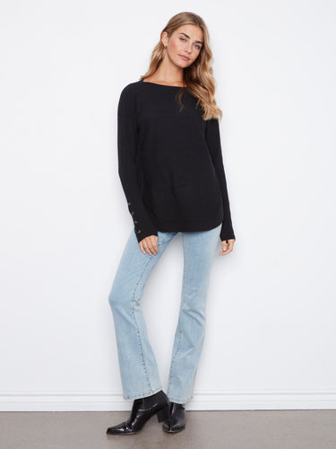 Elegant black sweater showcasing long ribbed sleeves and lace-up cuff details, perfect for a chic casual look by Charlie B.
