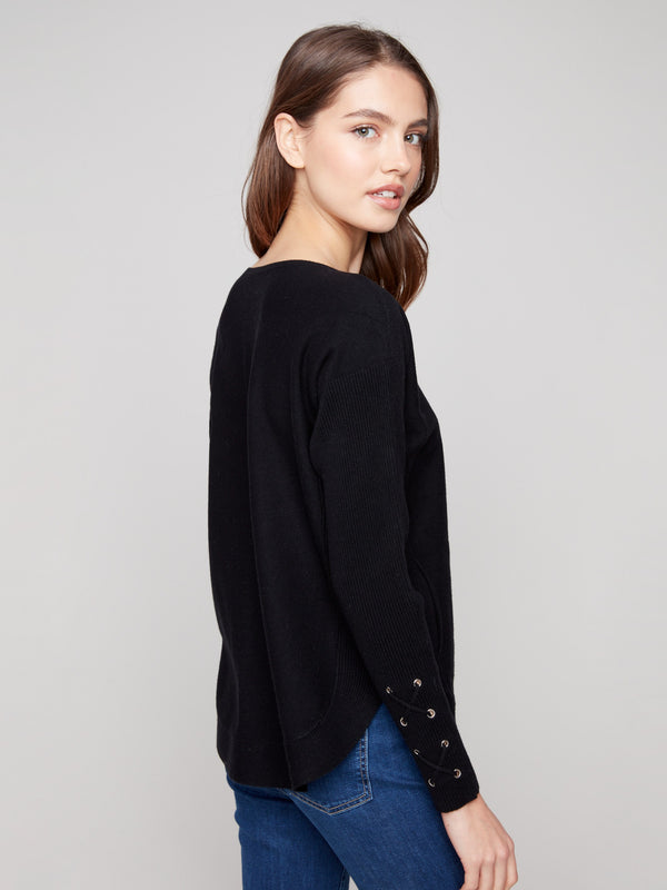 Stylish black knit sweater with practical side pockets, perfect for keeping essentials close at hand by Charlie B.