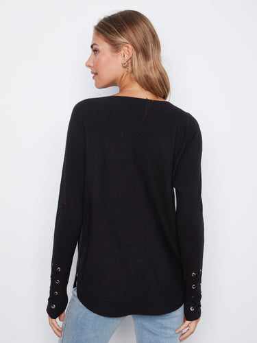 Sophisticated black knit sweater featuring rounded hem and intricate cuff lace-up detail for added flair by Charlie B.