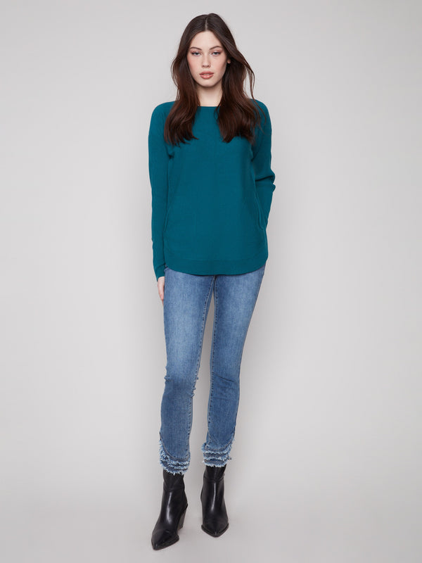 Elegant evergreen sweater with convenient side pockets and chic lace-up cuffs, adding a modern touch by Charlie B.