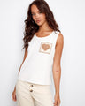 Ecru knit tank top featuring a crochet heart pattern on the pocket, paired with a stylish scoop neckline by Charlie B.