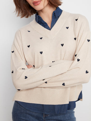 Featuring drop shoulders and long sleeves, this sweater offers comfort and style with its embroidered hearts by Charlie B.