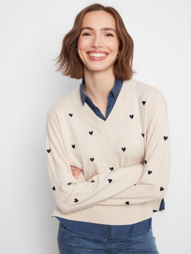 Embroidered hearts adorn this elegant sweater, complete with a stylish layered shirt collar and hem by Charlie B.