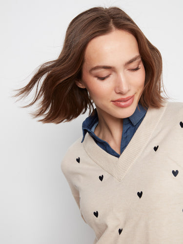 Long sleeves enhance the cozy appeal of this embroidered heart sweater, featuring a classic layered shirt hem by Charlie B.