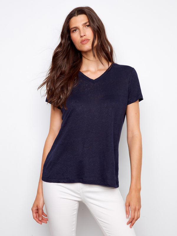 Navy V-neck T-shirt in a relaxed fit, paired effortlessly with white pants for a casual look by Charlie B.