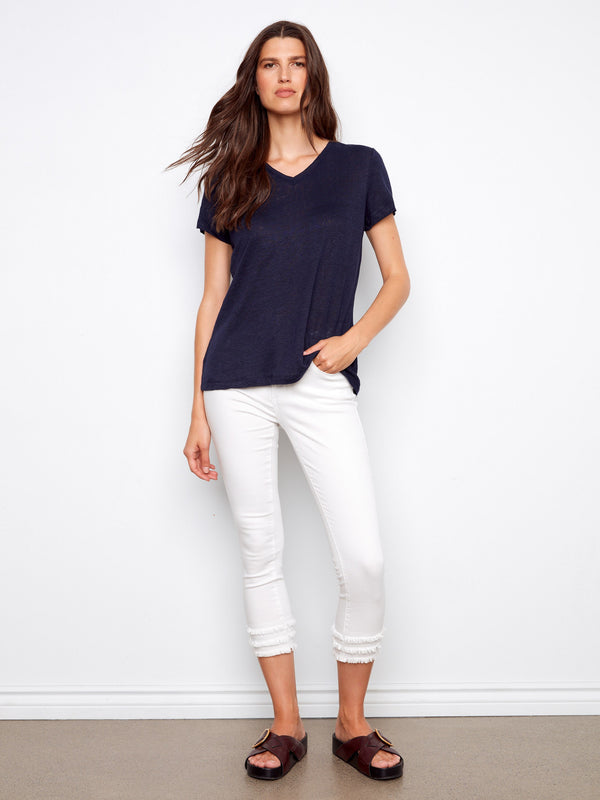 Navy short-sleeve T-shirt styled with white pants, offering a comfortable and chic appearance by Charlie B.