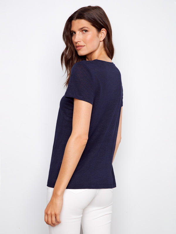 Linen blend navy T-shirt featuring short sleeves, casually styled with white pants for everyday wear by Charlie B.