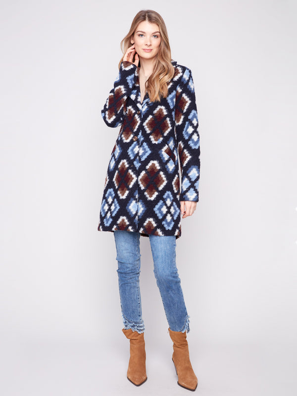 Crochet coat in twilight with a tailored collar, featuring geometric patterns and elegant design by Charlie B.