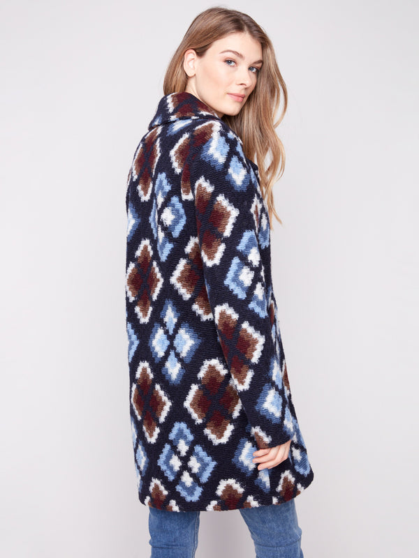 Geometric pattern crochet coat in twilight, complete with welt pockets on the front for added functionality by Charlie B.
