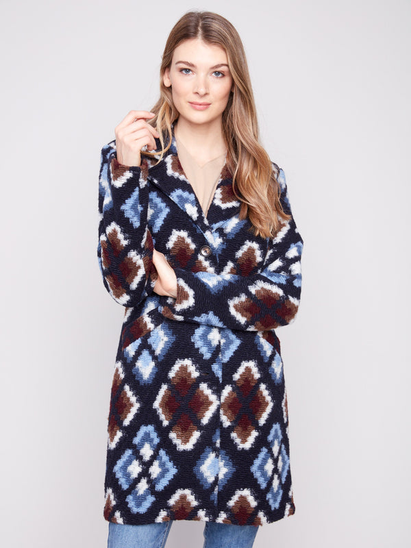 Unlined crochet coat in twilight, adorned with a striking geometric pattern and sophisticated style by Charlie B.