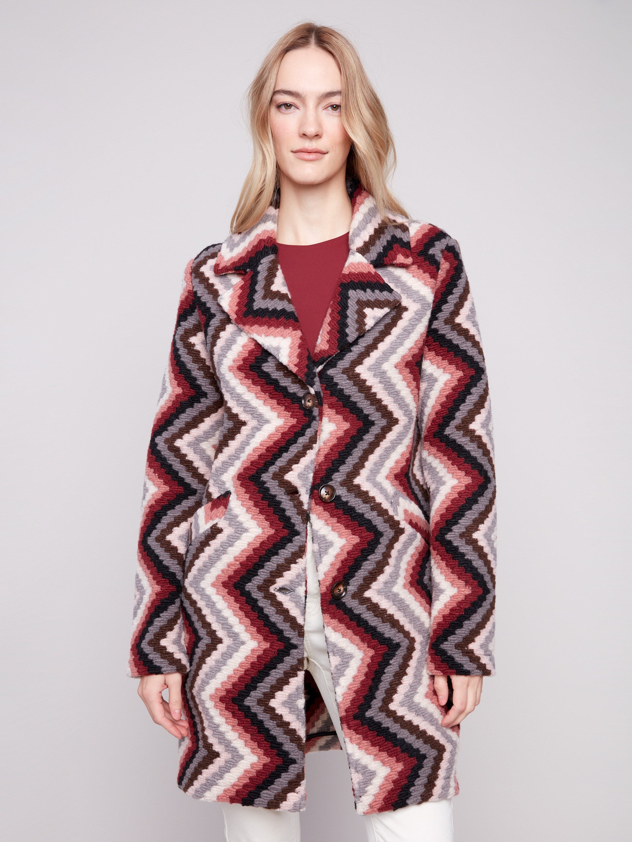 Crochet coat in primrose with tailored collar and geometric design. Features welt pockets for style by Charlie B.
