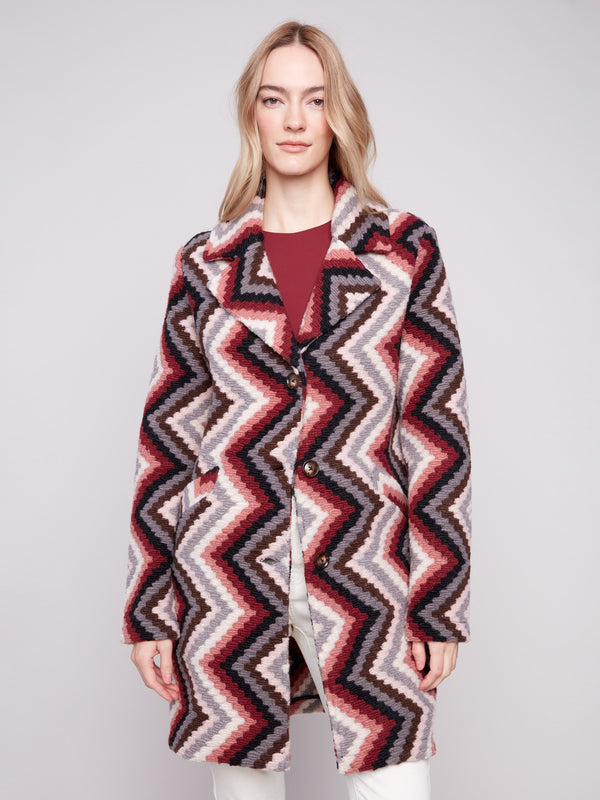 Crochet coat in primrose with tailored collar and geometric design. Features welt pockets for style by Charlie B.
