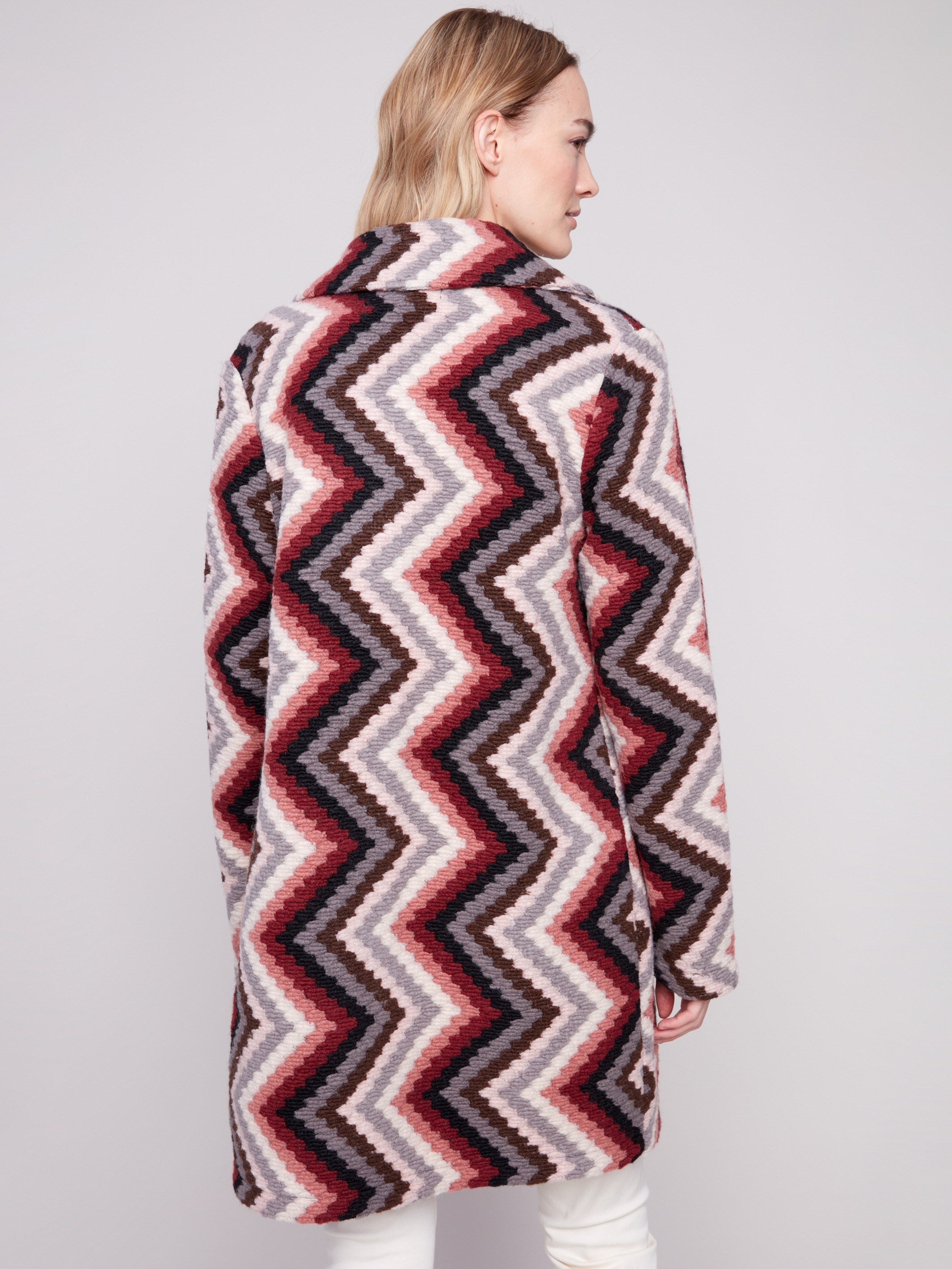 Stylish primrose crochet coat adorned with a tailored collar and vibrant geometric motif by Charlie B.