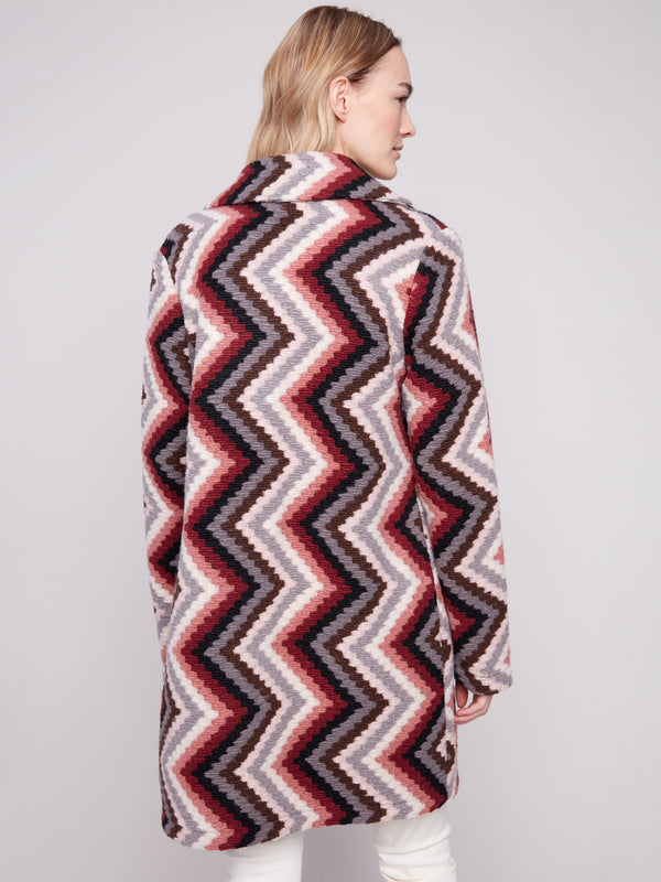 Stylish primrose crochet coat adorned with a tailored collar and vibrant geometric motif by Charlie B.