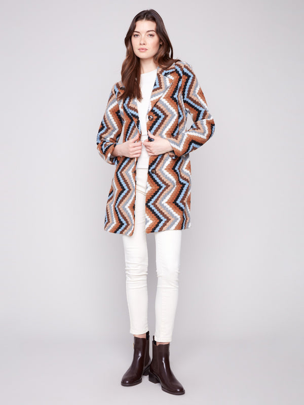 Sepia crochet coat with a tailored collar, showcasing a bold geometric pattern and unlined design for comfort by Charlie B.