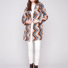 Sepia crochet coat with a tailored collar, showcasing a bold geometric pattern and unlined design for comfort by Charlie B.