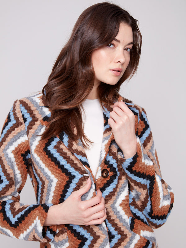 Button closure enhances the sleek look of this sepia crochet coat with its eye-catching geometric pattern by Charlie B.