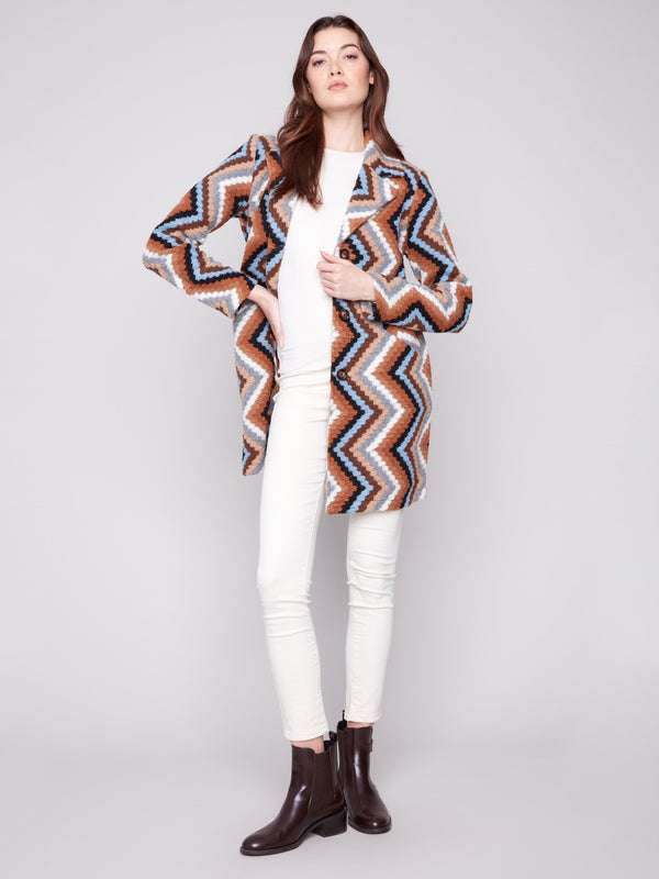 This sepia coat features a tailored collar and vibrant geometric design, offering both style and versatility by Charlie B.