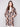 Welt pockets add functionality to this long crochet coat in sepia, highlighted by its unique geometric pattern by Charlie B.