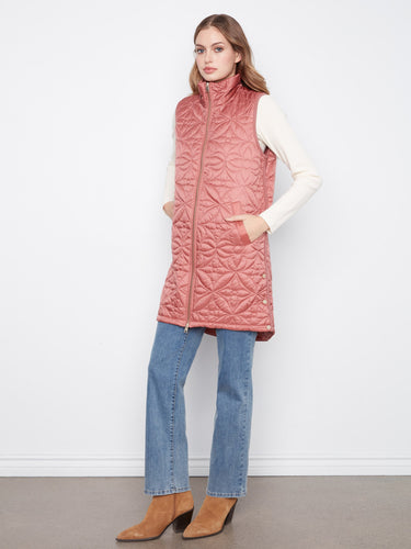 Side snap buttons on this rosebud puffer vest add versatility to its chic design by Charlie B.